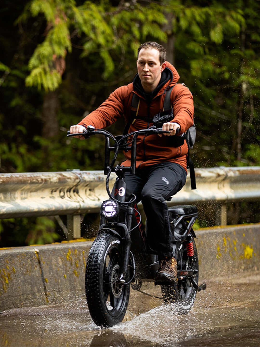H7 electric bike riding through a rainy outdoor environment, showcasing durability and weather resistance for all conditions.