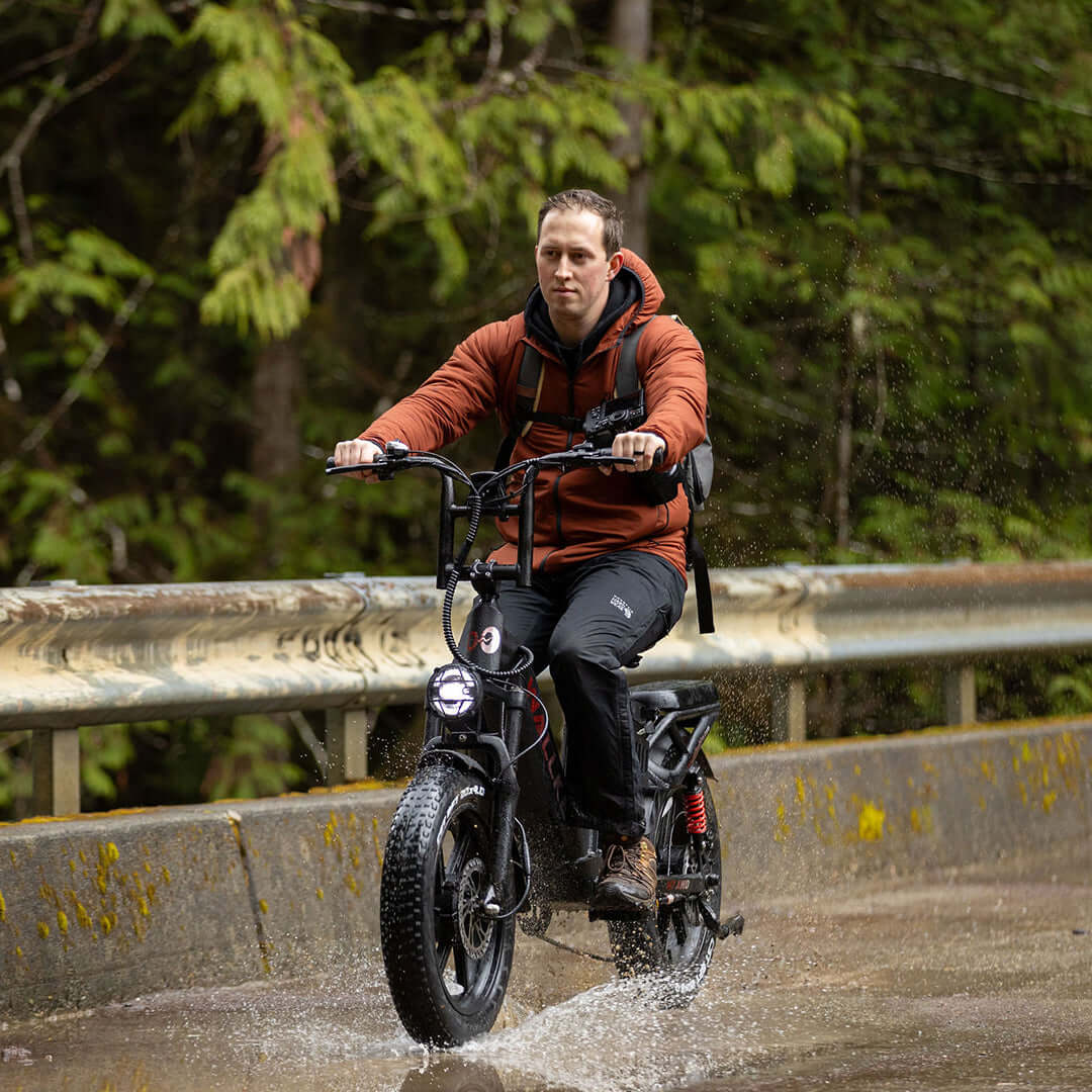 Rainy day ride on H7 Step-thru e-bike, equipped with fat tires and dual motors for a stable and smooth ride.